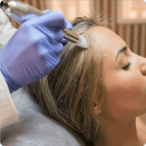 Woman receiving a GFC hair treatment.